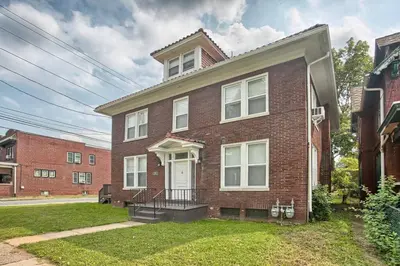a brick house with a white door at Suites on Seneca - Gorgeous One Bedroom Apartment in Harrisburg