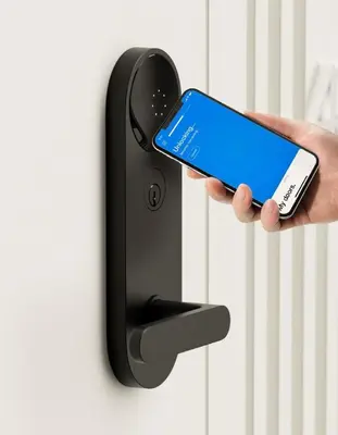 a person holding a cell phone in front of a door at 24-18 New Gramercy Studio W D in Unit Fully Reno in New York