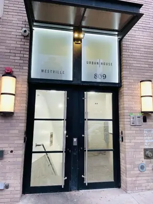 a store front with glass doors on a brick building at 809-4B Studio Balcony W D Prime location in New York