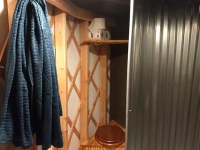 a room with a wooden closet with a blue towel at Livingston Manor YURT in Parksville