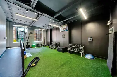 a room with a baseball bat and a green carpet at The Heritage Suite Central Old City Near the Liberty Bell in Philadelphia