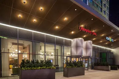 a store front of a building at night at Home2 Suites By Hilton New York Times Square in New York
