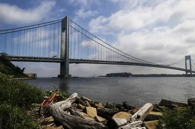 a bridge over the water with a bike parked in front at New York City Private Bedroom Near The Free Ferry Boat! in Stapleton