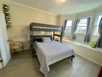 a bedroom with a bunk bed and two windows at New York City Private Bedroom Near The Free Ferry Boat! in Stapleton