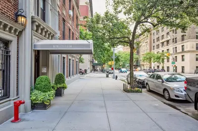 a sidewalk in a city with a red fire hydrant at UWS 1BR w Gym Doorman nr Riverside Park NYC-511 in New York