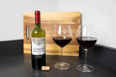 a bottle of wine and two glasses on a counter at Thena Hotel- Lux Studio in Philadelphia