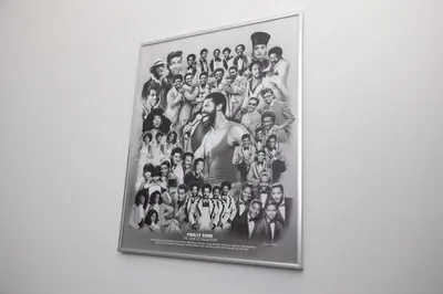 a framed picture of a group of people on a wall at Thena Hotel - Large Studio in Philadelphia