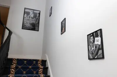 a group of pictures hanging on a wall at Thena Hotel - Large Studio in Philadelphia