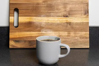 a cup of coffee sitting next to a wooden door at Thena Hotel - Beautiful 1 Bedroom in Philadelphia