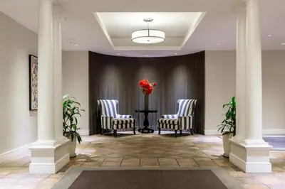 a lobby with three chairs and a table with a vase of flowers at Chelsea 1BR w Gym Concierge nr Penn Station NYC-438 in New York