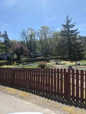 a wooden fence in front of a park at Deluxe Cabin Within Campground in Mifflinburg