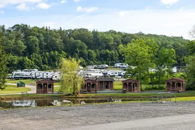 a view of a campground with a pond and trees at Cozy Cabin2 Within Campground in Mifflinburg