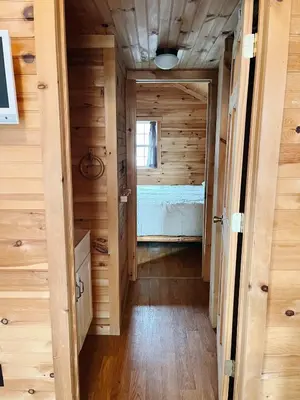 a hallway leading to a bedroom in a tiny house at Deluxe Cabin6 Within Campground in Mifflinburg