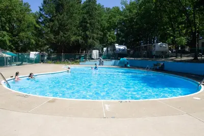 a group of people playing in a swimming pool at Deluxe Cabin6 Within Campground in Mifflinburg