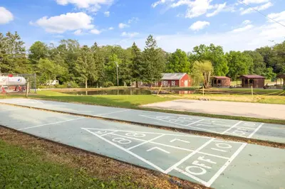 a parking lot with a bus stop sign on it at Deluxe Cabin7 Within Campground in Mifflinburg