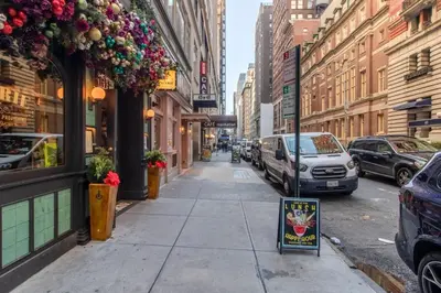 a city street with cars parked on the street at Midtown 1br w doorman gym wd nr Rock Center NYC-1127 in New York