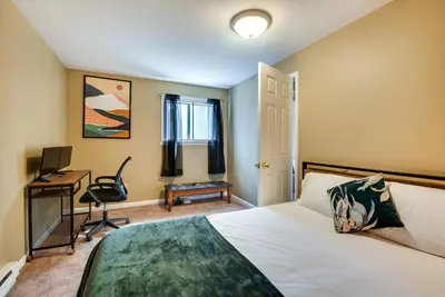 a bedroom with a bed and a desk and a computer at Serene Pocono Pines Home 2 Mi to Lake Naomi Beach in Pocono Pines